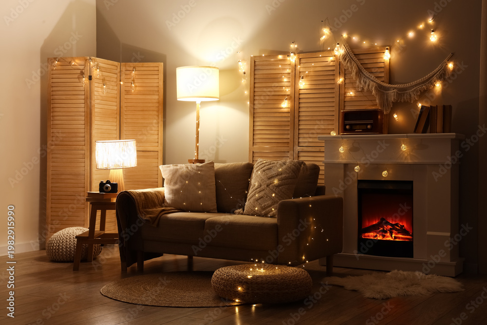 Naklejka premium Interior of dark living room with sofa, fireplace and glowing lights