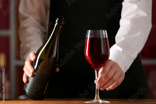 Female bartender with bottl...