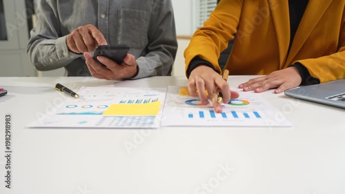 Businessmen team or financial data analysts working with tablets and laptop computers and data graphs together. Plan to analyzing projects in the office.