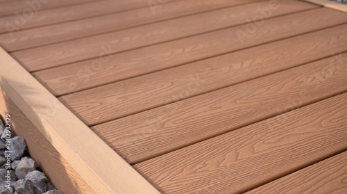 Obraz na plátně Detail of WPC composite terrace decking with wood texture and corner trim, modern outdoor flooring surface, close-up