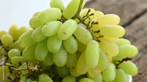 Fresh green grape or shine muscat grape fruit. Healthy eating. Fresh ripe grapes on wooden table, close up