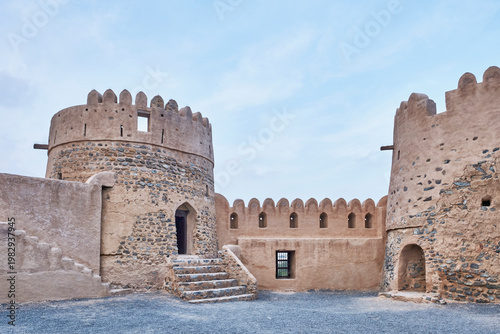 Inside Fujairah Fort historical courtyard with watchtowers in UAE