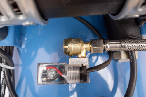 Fotografía Close-up of a heavy-duty brass and steel one-way check valve installed on an air