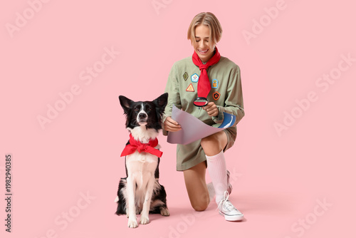 Valokuva Boy scout with cute Border Collie dog and map on pink background