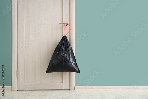 Full garbage bag hanging on...