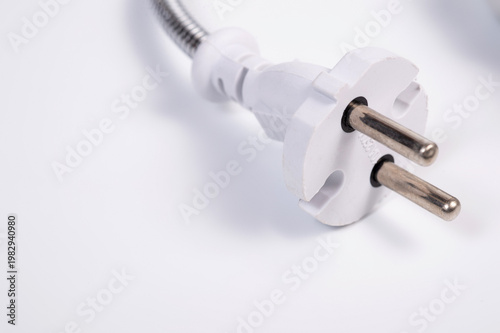 An electrical plug and a lamp socket connected by a flexible wire.