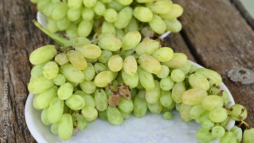 Fresh green grape or shine muscat grape fruit. Healthy eating. Fresh ripe grapes on wooden table, close up