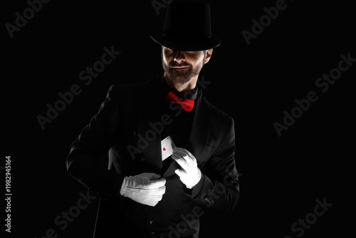Male magician taking playin...