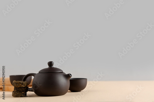 Teapot with cups of tea and...
