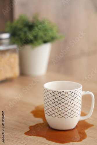 Cup and spilled coffee on t...