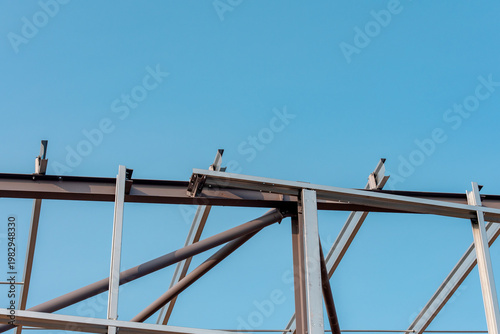 Tableau sur toile Construction of a metal framework under a clear blue sky during daylight hours