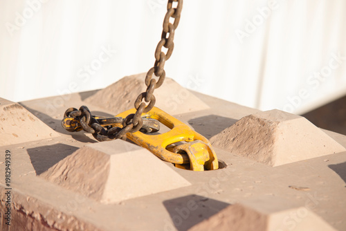 Billede på lærred Strong chain connects to hook on block for lifting at construction site in broad