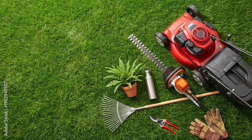 Gardening tools and equipment arranged on green grass background  
