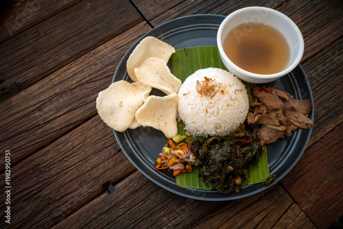 Sei Sapi or Beef Sei, Indonesian traditional smoked beef dish and rice on a dark plate