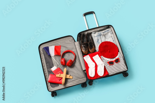Open suitcase with clothes,...