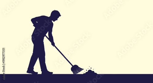 Silhouette of a person sweeping dirt with a broom.