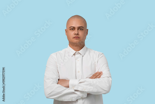 Bald businessman on blue ba...