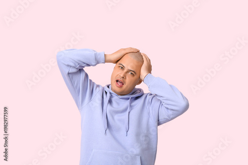 Shocked bald young man on p...