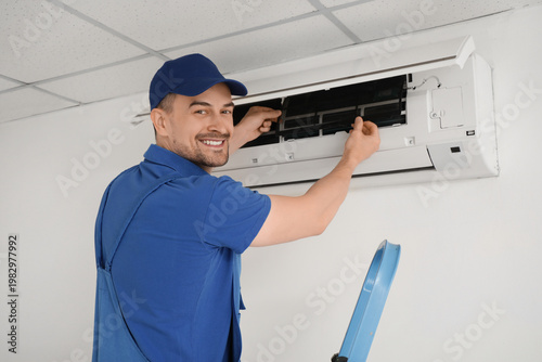 Male technician repairing a...