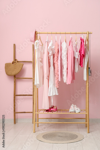 Rack with stylish clothes n...