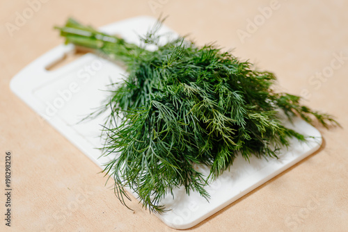 Photography bunch of green dill on white board, healthy food, greenery