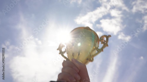 Upward Shot Capturing Gleaming Trophy Signifying Significant Sporting Or Achievement Victory
