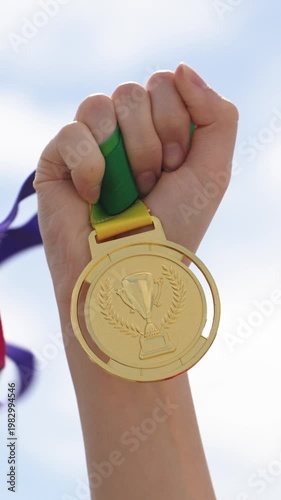 Victory Is Confidently Displayed Beneath Radiant Sky With Medals And Clenched Fist Uplifted