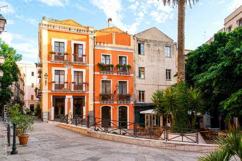 Colorful townhouses and small outdoor seating in Piazzetta Savoia, Cagliari, Sardinia, Italy