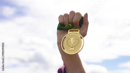 Victory With Patriotic Ribbon. Closeup Of Hand Holding Medal With Patriotic Ribbon Against Overcast Sky
