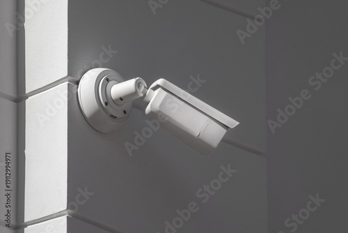 White security camera mounted on a wall corner