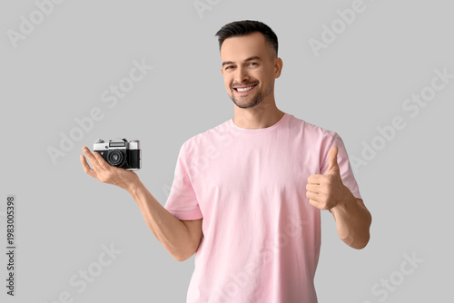 Happy young man with photo ...