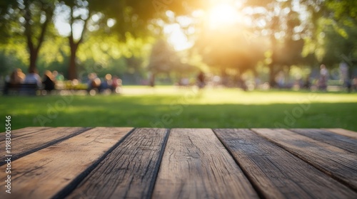 People enjoying a sunny day in a park with a wooden table in the foreground