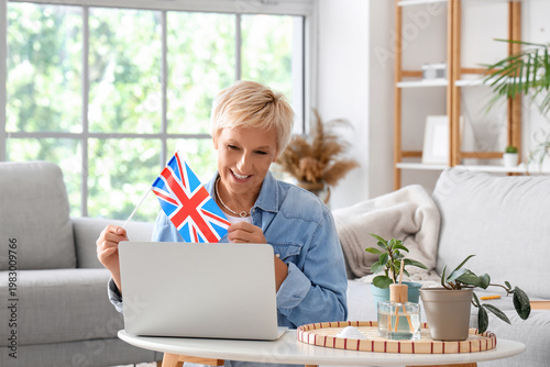 Mature woman with UK flag learning English language online at home