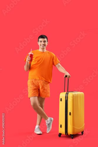 Male tourist with suitcase ...