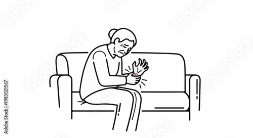Elderly person in pain on couch, holding wrist