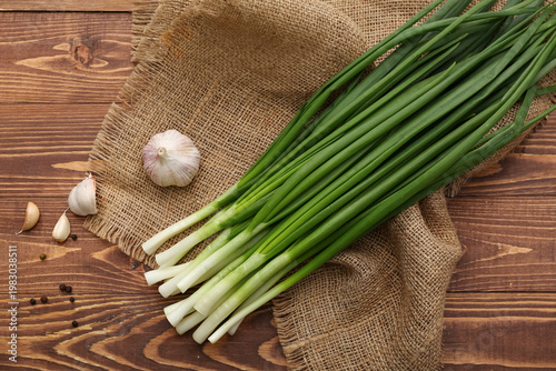Fresh green onion on wooden background