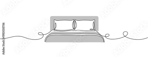 Bed with pillows arranged on minimalist white background