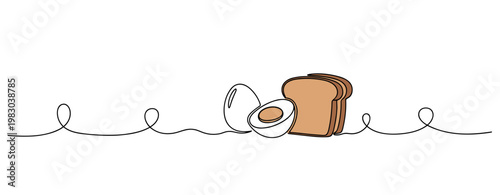 Sliced boiled egg and toast pieces arranged on white surface