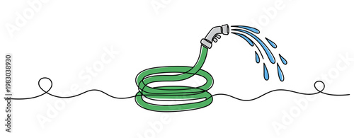 Garden hose spraying water while coiled on white background