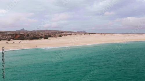 Drone view of Morro de Areia Natural Reserve and Praia de Chaves,green ocean,sandy beach,desert dunes and luxury resort,Boa Vista,Cape Verde.
