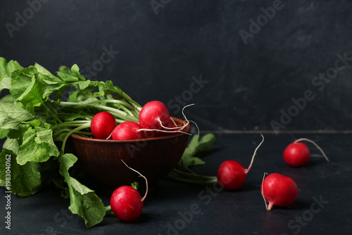 Bowl of ripe radish with gr...
