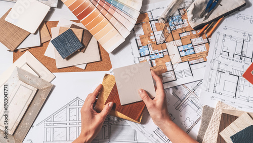 Interior design planning with architectural drawings, color swatches and material samples, residential renovation concept, finish selection and home design workflow.