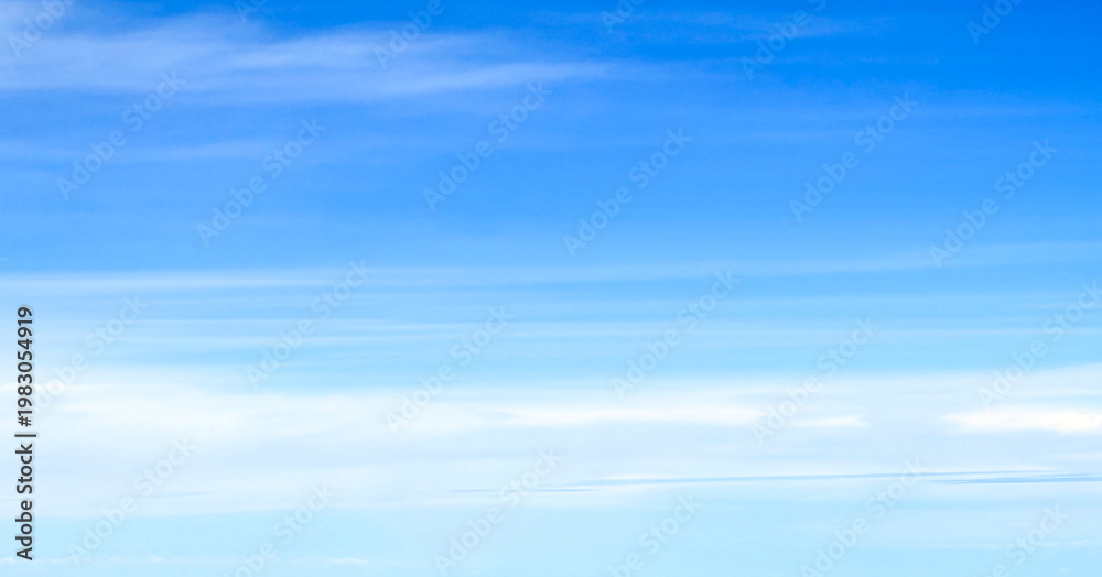 Obraz premium Panoramic blue sky with long white wispy clouds, minimalist nature gradient background and sky replacement banner with copy space