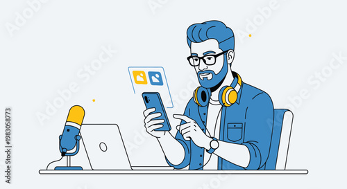 Man with headphones and glasses working on laptop and phone, podcasting setup