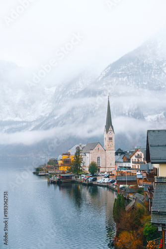 Принти на полотні Hallstatt village on lake shore surrounded by misty snowy mountains