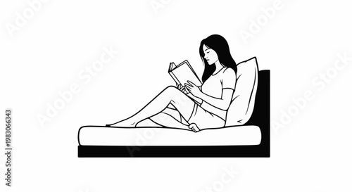 A woman reclines on a bed, engrossed in reading a book