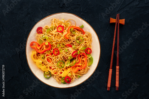 Hakka noodles with vegetables, peppers and green onions, overhead shot