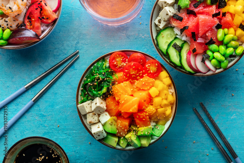 Poke bowl assortment. Rice with salmon, shrimps, and grapefruit, overhead shot