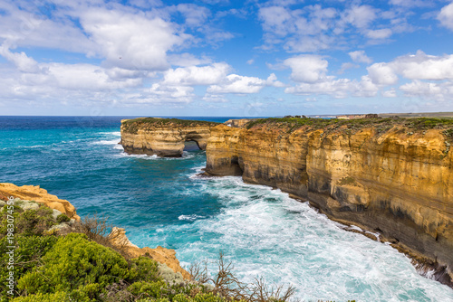 Breathtaking rock formations at Loch Ard Gorge meet turquoise waters along the scenic Great Ocean Road in Victoria, showcasing nature's beauty in Australia.