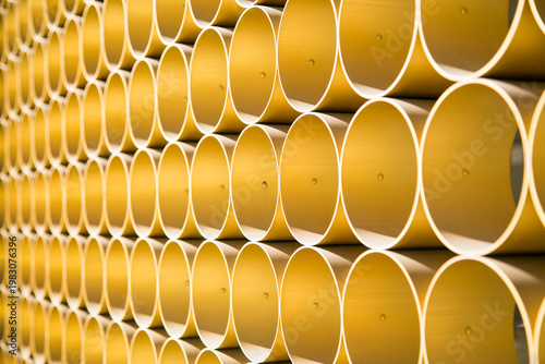 Repeating yellow cylindrical pattern industrial geometric background texture